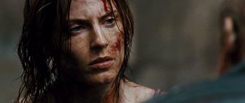 Movie still from “Pandorum” (2009), directed by Christian Alvart – A person with blood all over their face; Close Up shot, Over the shoulder angle