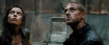 Movie still from “Pandorum” (2009), directed by Christian Alvart – A person sitting at a table; Close Up shot, Low angle