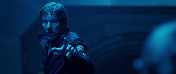 Movie still from “Pandorum” (2009), directed by Christian Alvart – A man in a black jacket is pointing his finger; Medium shot, Over the shoulder angle