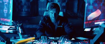 Movie still from “Pandorum” (2009), directed by Christian Alvart – A man sitting in front of a computer keyboard; Medium shot, Low angle