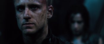 Movie still from “Pandorum” (2009), directed by Christian Alvart – A man's face in the dark; Close Up shot, Low angle