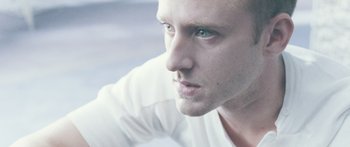 Movie still from “Pandorum” (2009), directed by Christian Alvart – A man's face in a white shirt; Close Up shot, Low angle