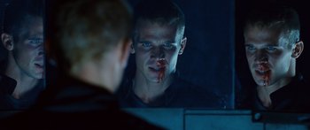 Movie still from “Pandorum” (2009), directed by Christian Alvart – A man with blood on his face looking into a mirror; Close Up shot, Over the shoulder angle