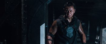 Movie still from “Pandorum” (2009), directed by Christian Alvart – A man in a black shirt is standing in a room; Medium shot, Low angle