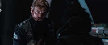 Movie still from “Pandorum” (2009), directed by Christian Alvart – A person wearing a black shirt; Close Up shot, Over the shoulder angle