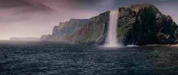Movie still from “Pandorum” (2009), directed by Christian Alvart – A large waterfall in the middle of a body of water; Extreme Wide shot, Low angle