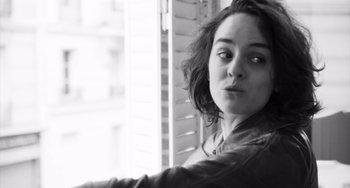 Movie still from “Paris, 13th District” (2021), directed by Jacques Audiard – Black and white photograph of a woman looking out of a window; Close Up shot, Low angle