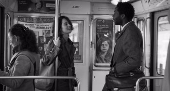 Movie still from “Paris, 13th District” (2021), directed by Jacques Audiard – Two people on a train talking to each other; Medium shot, Over the shoulder angle