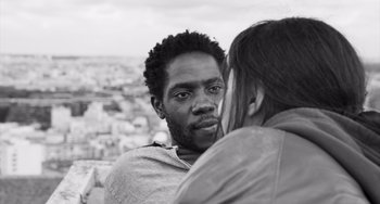 Movie still from “Paris, 13th District” (2021), directed by Jacques Audiard – A black and white photo of a man and a woman; Close Up shot, Over the shoulder angle