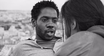 Movie still from “Paris, 13th District” (2021), directed by Jacques Audiard – A black and white photo of a man and a woman talking; Close Up shot, Low angle
