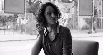 Movie still from “Paris, 13th District” (2021), directed by Jacques Audiard – Black and white photograph of a woman holding a cell phone; Close Up shot, Low angle