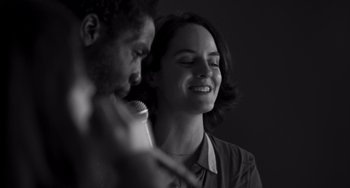 Movie still from “Paris, 13th District” (2021), directed by Jacques Audiard – A man and a woman singing into microphones; Close Up shot, Low angle