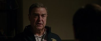Movie still from “Patriots Day” (2016), directed by Peter Berg – An older man is looking at the camera; Close Up shot, Over the shoulder angle