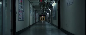 Movie still from “Patriots Day” (2016), directed by Peter Berg – A person is walking down a long hallway; Extreme Wide shot, High angle