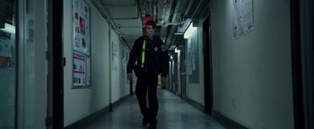 Movie still from “Patriots Day” (2016), directed by Peter Berg – A police officer walking down a long hallway; Wide shot, Low angle