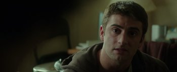 Movie still from “Patriots Day” (2016), directed by Peter Berg – A person sitting down; Close Up shot, Over the shoulder angle