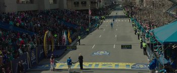 Movie still from “Patriots Day” (2016), directed by Peter Berg – A group of people standing on the side of a road; Extreme Wide shot, High angle