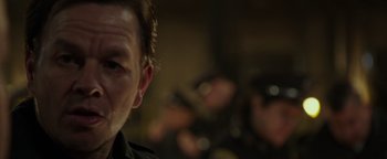 Movie still from “Patriots Day” (2016), directed by Peter Berg – A man's face in a dark room; Close Up shot, Over the shoulder angle