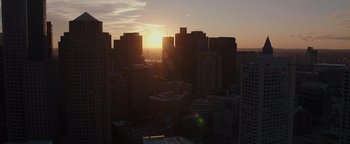 Movie still from “Patriots Day” (2016), directed by Peter Berg – The sun is setting over a large city; Extreme Wide shot, High angle