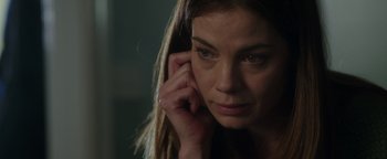 Movie still from “Patriots Day” (2016), directed by Peter Berg – A person holding a cell phone up to their ear; Close Up shot, Over the shoulder angle