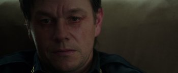 Movie still from “Patriots Day” (2016), directed by Peter Berg – A man's face with a sad look on his face; Close Up shot, Over the shoulder angle