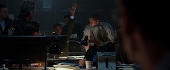 Movie still from “Patriots Day” (2016), directed by Peter Berg – A group of people sitting at a table in front of a computer; Medium shot, High angle