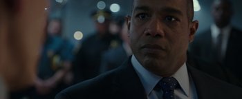 Movie still from “Patriots Day” (2016), directed by Peter Berg – A man in a suit and tie; Close Up shot, Over the shoulder angle