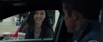 Movie still from “Patriots Day” (2016), directed by Peter Berg – A young woman sitting in the back seat of a car; Close Up shot, Over the shoulder angle