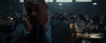 Movie still from “Patriots Day” (2016), directed by Peter Berg – A man in a suit talking on a phone; Close Up shot, Low angle