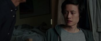 Movie still from “Patriots Day” (2016), directed by Peter Berg – A man in a gray shirt and a green jacket; Close Up shot, Over the shoulder angle