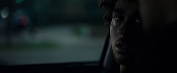 Movie still from “Patriots Day” (2016), directed by Peter Berg – A person in a car looking at the camera; Close Up shot, Over the shoulder angle