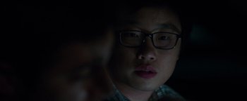 Movie still from “Patriots Day” (2016), directed by Peter Berg – A person wearing glasses; Close Up shot, Over the shoulder angle