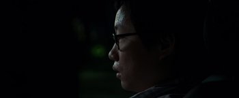 Movie still from “Patriots Day” (2016), directed by Peter Berg – A man with glasses looking to the side; Close Up shot, Low angle