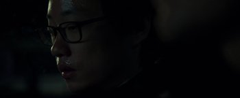 Movie still from “Patriots Day” (2016), directed by Peter Berg – A man with glasses is looking at the camera; Close Up shot, Over the shoulder angle