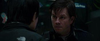 Movie still from “Patriots Day” (2016), directed by Peter Berg – A man in a police uniform talking to another man; Close Up shot, Over the shoulder angle
