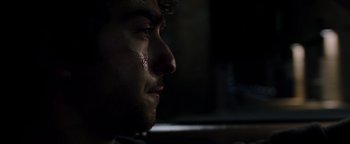 Movie still from “Patriots Day” (2016), directed by Peter Berg – A man's face in the dark; Close Up shot, Over the shoulder angle