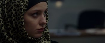 Movie still from “Patriots Day” (2016), directed by Peter Berg – A woman wearing a head scarf and looking to her left; Close Up shot, Over the shoulder angle