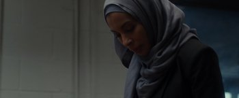 Movie still from “Patriots Day” (2016), directed by Peter Berg – A woman wearing a hijab looking down at her face; Close Up shot, Low angle