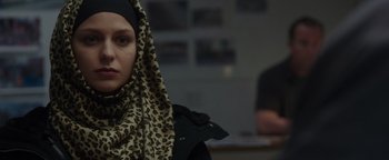 Movie still from “Patriots Day” (2016), directed by Peter Berg – A woman wearing a leopard print head scarf; Close Up shot, Over the shoulder angle