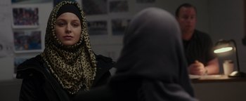 Movie still from “Patriots Day” (2016), directed by Peter Berg – A woman wearing a leopard print head scarf; Close Up shot, Over the shoulder angle