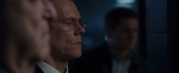 Movie still from “Patriots Day” (2016), directed by Peter Berg – A man with glasses is looking into the distance; Close Up shot, Over the shoulder angle