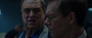 Movie still from “Patriots Day” (2016), directed by Peter Berg – Two men are looking at each other in the dark; Close Up shot, Over the shoulder angle