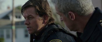 Movie still from “Patriots Day” (2016), directed by Peter Berg – Two police officers standing next to each other; Close Up shot, Over the shoulder angle
