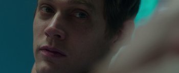 Movie still from “Patriots Day” (2016), directed by Peter Berg – A man's face with a dark background; Extreme Close Up shot, Overhead angle