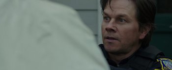 Movie still from “Patriots Day” (2016), directed by Peter Berg – A person looking at something; Close Up shot, Over the shoulder angle