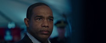 Movie still from “Patriots Day” (2016), directed by Peter Berg – A person wearing a suit and tie; Close Up shot, Low angle