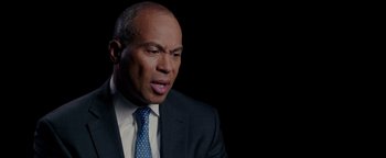 Movie still from “Patriots Day” (2016), directed by Peter Berg – A man in a suit and a blue tie; Close Up shot, Low angle