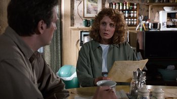 Movie still from “The Bridges of Madison County” (1995), directed by Clint Eastwood – A woman sitting at a table in front of a man; Medium shot, Over the shoulder angle