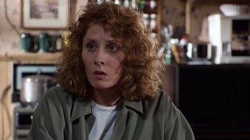 Movie still from “The Bridges of Madison County” (1995), directed by Clint Eastwood – A person with curly hair; Close Up shot, Over the shoulder angle