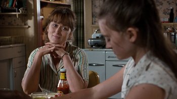 Movie still from “The Bridges of Madison County” (1995), directed by Clint Eastwood – A woman sitting at a table with another woman; Close Up shot, Over the shoulder angle